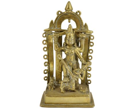 DURGA MAHISASURAMARDINI, WESTERN DECCAN, INDIA, 18TH CENTURY brass shrine, the four-armed goddess wielding her trident, the b