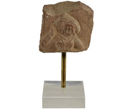 A KUSHAN PINK SANDSTONE FRAGMENT, NORTHERN INDIA, 3RD/4TH CENTURY probably from a stupa railing post, carved in relief on bot