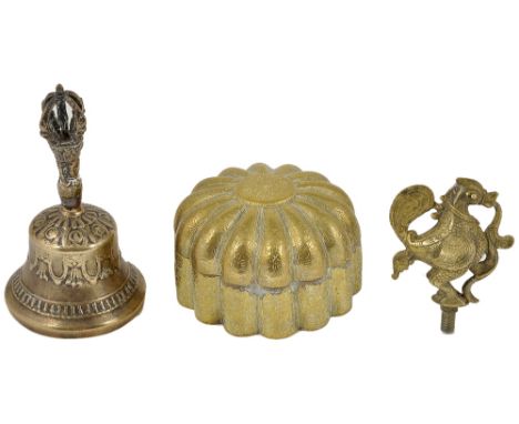 THREE BRASS OBJECTS comprising a Tibetan ritual bell (ghanta), a lamp finial in the form of a hamsa, and a pan-dan, of lobed 