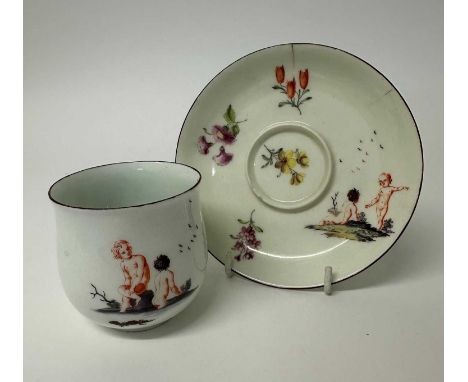 Chelsea coffee cup and trembleuse saucer, circa 1755, painted with floral sprays and a pair of putti, red-lined rims, anchor 