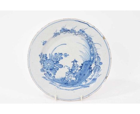 18th century English Delft plate, painted in blue with a Chinese figure, 22cm diameterSome rim chips and crazing. Please see 
