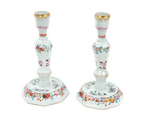 Pair of 18th century Chinese export porcelain candlesticks, of European silver shape, painted in famille rose and grisaille e