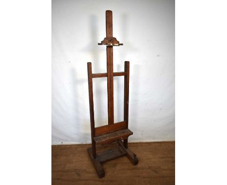 Edwardian oak adjustable artist's easel, on sledge base and castors, 56cm wide