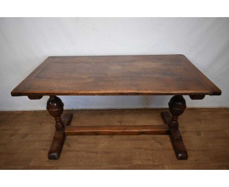 17th century style oak refectory table, the plank top with cleated ends, on cup and cover supports and sledge bases, 151cm lo