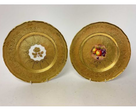 Two Royal Worcester plates, the first with central panel painted with fruit, signed by Freeman, on gilt-tooled ground, the ot