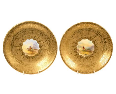 Pair of Royal Worcester plates, polychrome painted with pheasants in central panels, on finely tooled gilt patterned grounds,