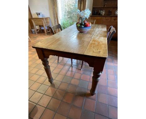Antique pine kitchen table, the plank top raised on turned legs, 183cm long x 67cm deep x 73cm highSound original condition .