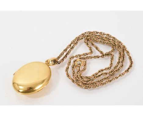 19th century French gold oval locket on a yellow metal rope twist chain  Locket has the French eagle's head mark for 18ct, we