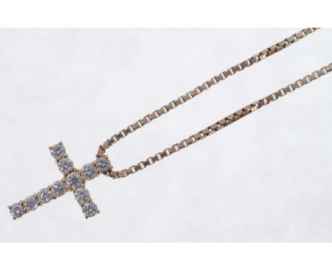 Diamond cross pendant with eleven brilliant cut diamonds in 18ct gold setting on 9ct gold chain. Estimated total diamond weig
