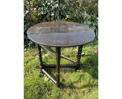 17th century oak narrow drop leaf table, the elliptical hinged top on bobbin turned supports and sledge base, 76 x 76cm 