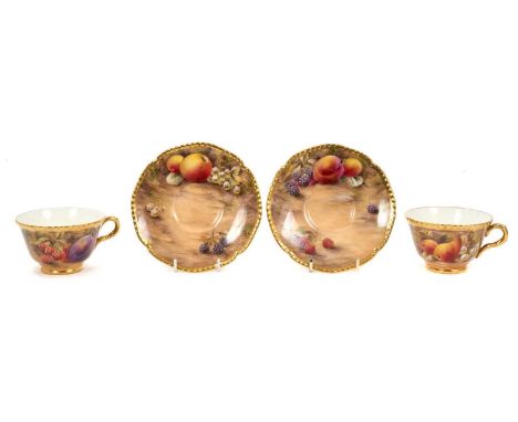 Pair of Royal Worcester cabinet cups and saucers, dated 1954/55, painted with fruit, signed P. Love, the saucers 15cm diamete
