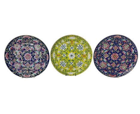 Three 19th century Chinese porcelain plates, decorated in enamels with bats and auspicious symbols amongst scrolling foliage,