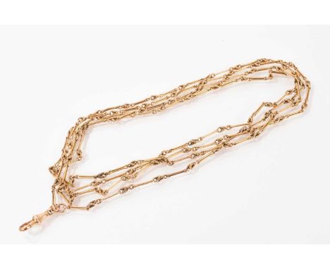 Late Victorian gold/yellow metal guard chain with fancy links, marked ‘15’ on the clasp, approximately 144cm long Weight 31.3