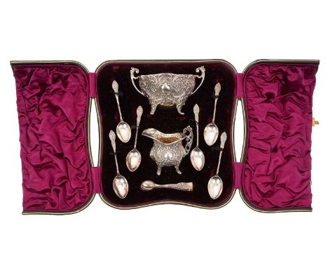 Late Victorian silver sugar and cream set, with scroll and lattice work decoration, comprising cream jug, twin handled sugar 