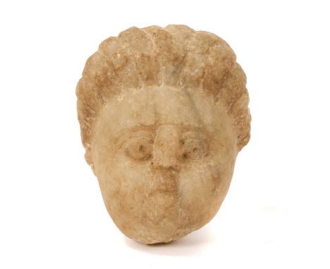 Gallo Roman carved limestone head of Eros, 9cm high. It has been suggested that the quantity of spirite in the stone suggests