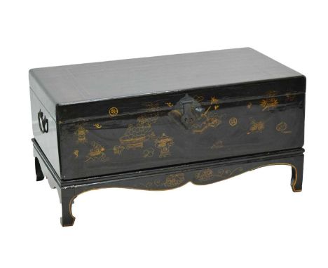 Chinese black lacquer trunk or chest on stand, the hinged rectangular cover and front decorated in gilt with auspicious Buddh