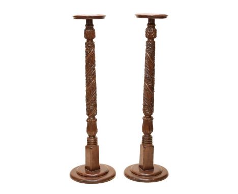 Pair of early 20th century carved mahogany torchères or plant stands, each on circular step bases, 26.5cm (top diameter) x 13
