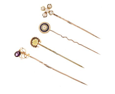 Four stick pins comprising an amethyst and seed pearl '15ct' stick pin, a horseshoe and yellow enamel flower stick pin, anoth