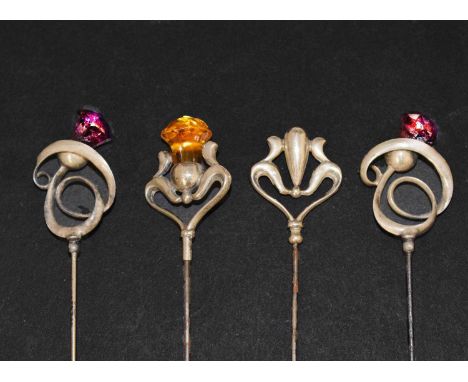Two Charles Horner silver hat pins, each of Art Nouveau design formed as a thistle, Chester 1913, 26cm long, and two similar 
