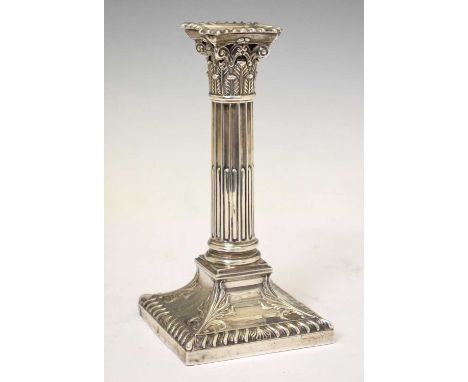 George V silver candlestick modeled as a Corinthian column on a stepped square base, sponsor's mark of Thomas A Scott, Sheffi