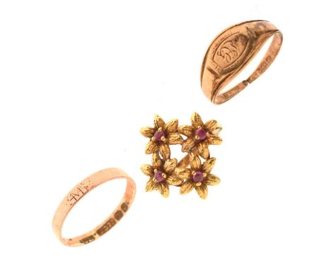 Three gold rings, comprising two 9ct gold bands, and a dress ring, the head formed of four flowerheads each set a ruby, to an