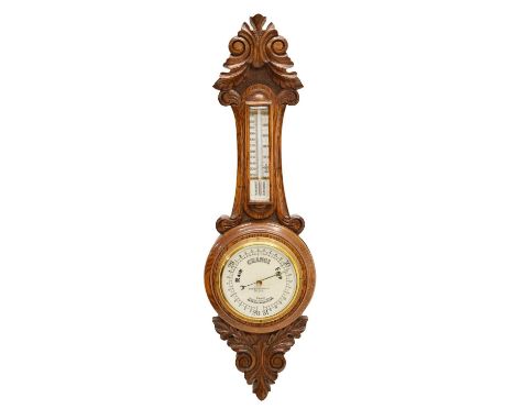 Early 20th century carved oak aneroid barometer, M.W. Dunscombe Ltd., with thermometer, 66cm high 