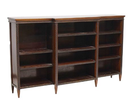 Chippendale-style mahogany breakfront bookcase, each section fitted with three adjustable shelves, raised on tapering support