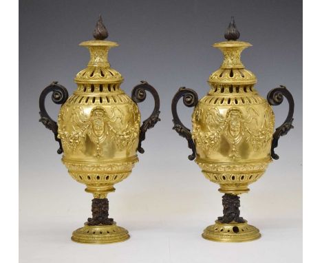 Impressive pair of French style gilt and patinated bronze urns, each with flambeau finial, the ovoid body with mask and swag 