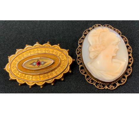 A Victorian 9ct gold oval ruby and seed pearl brooch, stamped 375, 4.2g gross; a cameo brooch (2) 