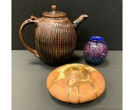 A Studio Pottery ribbed ovoid teapot, glazed in brown and black, 23.5cm high, impressed seal mark S.N.;  a relief moulded ovo