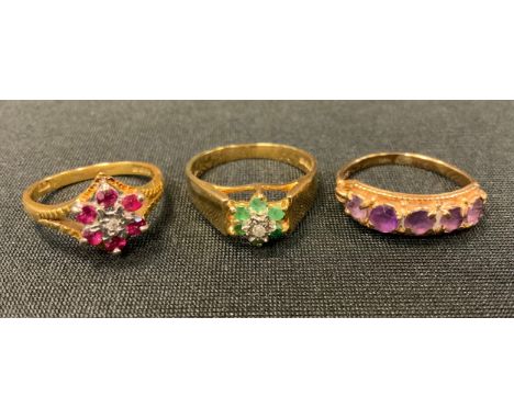 An 18ct gold ruby and diamond open crest cluster ring, 2.9g gross;  an emerald and diamond ring 9ct gold shank;  an amethyst 