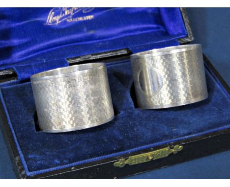 A boxed set of a pair of silver engine turned napkin rings, Birmingham 1922 by Lester &amp; Leafe, 2 ozs approximately 