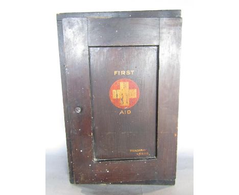 A wall mounted First Aid Box from Thackeray Leeds, with four graduated drawers containing original contents of bandages, gauz