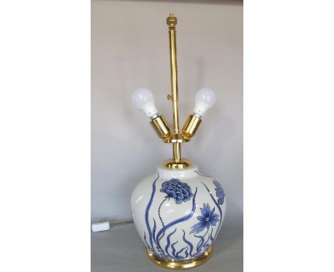 A ginger jar shaped floral glazed table lamp, with two fixings and adjustable shade height 