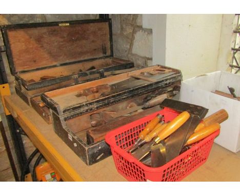 Two vintage stained pine framed portable carpenters tool boxes containing a variety of various hand tools, planes, saws/chise