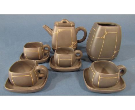 An oriental style tea set with symmetrical line pattern upon a dark brown ground comprising teapot, 10cm tall, four cups, fou