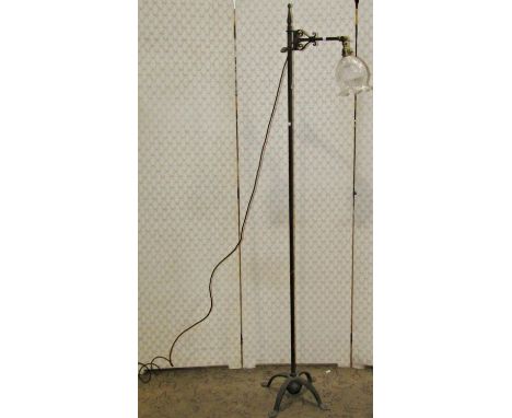 An iron work lamp standard with adjustable column and cut glass shade 