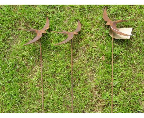 Three simple weathered light steel ornamental garden stakes with swift finials 