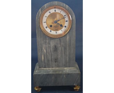 A 19th century French mantle clock in grey marble, the dial with engine turned detail in brass with enamelled chapter ring en