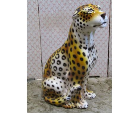 A ceramic leopard in seated pose 75 cm in height 