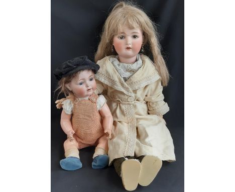 Two early 20th century German dolls both with Simon &amp; Halbig head with visible cracks/damage;  larger doll is by Kammer &