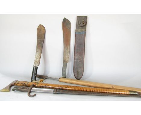 Two early 20th century bayonets, two machete type knives one in a leather sheath, a souvenir type axe and an autographed Coun