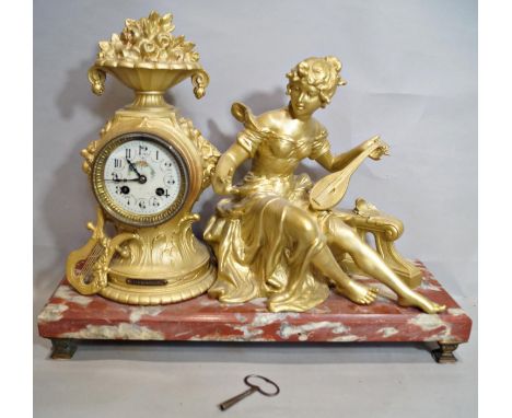 A 19th century French mantle clock, the marble base supporting a clock movement with eight day striking movement within a pai