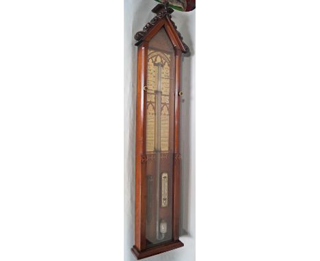 A Victorian Fitzroy Barometer housed in a walnut case, set beneath an architectural pediment with applied carved detail, with