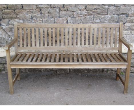 A contemporary light weight weathered hardwood three seat garden bench with slatted seat and back 158cm