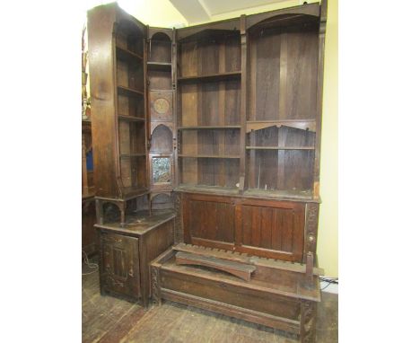 A substantial Art Nouveau oak sectional corner suite of multi purpose including a box settle with rising lid, adjacent cupboa