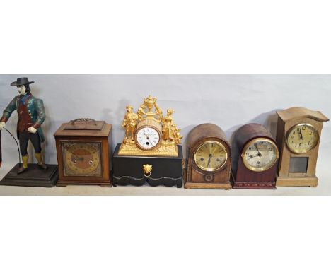 Six various mantle clocks of varying designs including a peddler clock, a 19th century mantle clock with later painted finish
