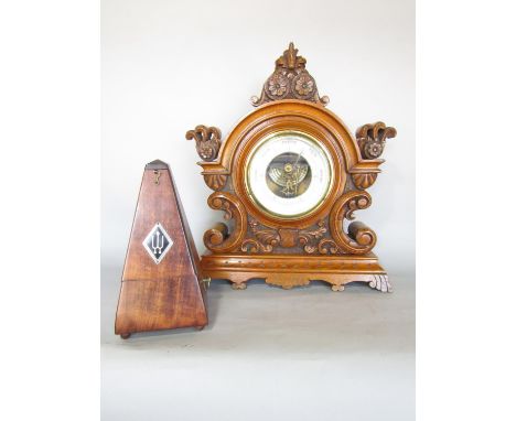 A Victorian oak mantel barometer with carved floral mounts, 34cm w x 39cm h, and Wittner mahogany cased metronome 23cm h. 