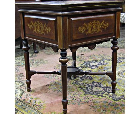 An Edwardian patent rose wood tea table of square cut form, the folding top, when open revealing a rising square cut tray and