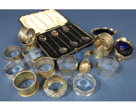 An assortment of twelve silver napkin rings, two salts, a silver curled handled caddy spoon, a single silver plate napkin and